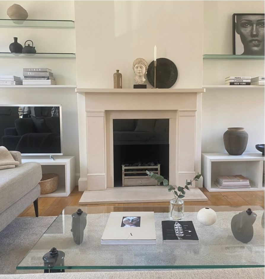 Cream sitting room with limestone fireplace, classical bust and curated shelves